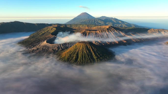 空中无人机超缩日出场景移动的云，雾和烟雾的喷发覆盖火山Mts. Bromo，塞默鲁，巴托克和威达顿，