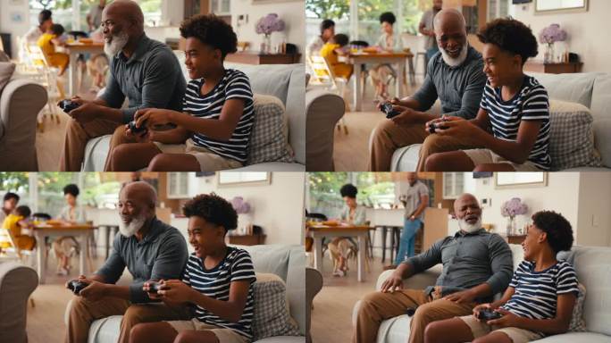 爷爷和孙子坐在家里的沙发上一起玩电子游戏