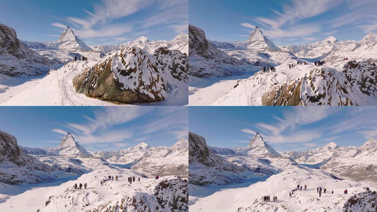 旅行者在瑞士马特洪峰山顶上的空中无人机视图。