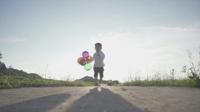 快乐小男孩拿着气球奔跑欢乐童年时光儿童节
