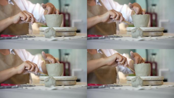 手工陶瓷作坊里陶土成型的过程，陶艺作坊里的妇女在陶艺作坊里塑造陶艺