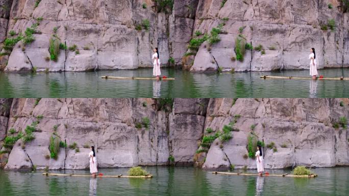 站在竹筏上在水中行走的古装女子