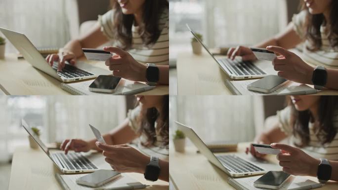 网上购物的女人用信用卡和笔记本电脑，跟踪镜头