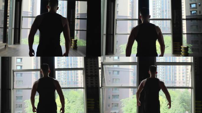身材健硕年轻男人走在健身房锻炼身体的背影
