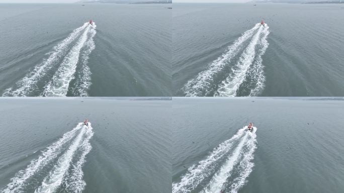 航拍跟随海面上一条快速航行的快艇
