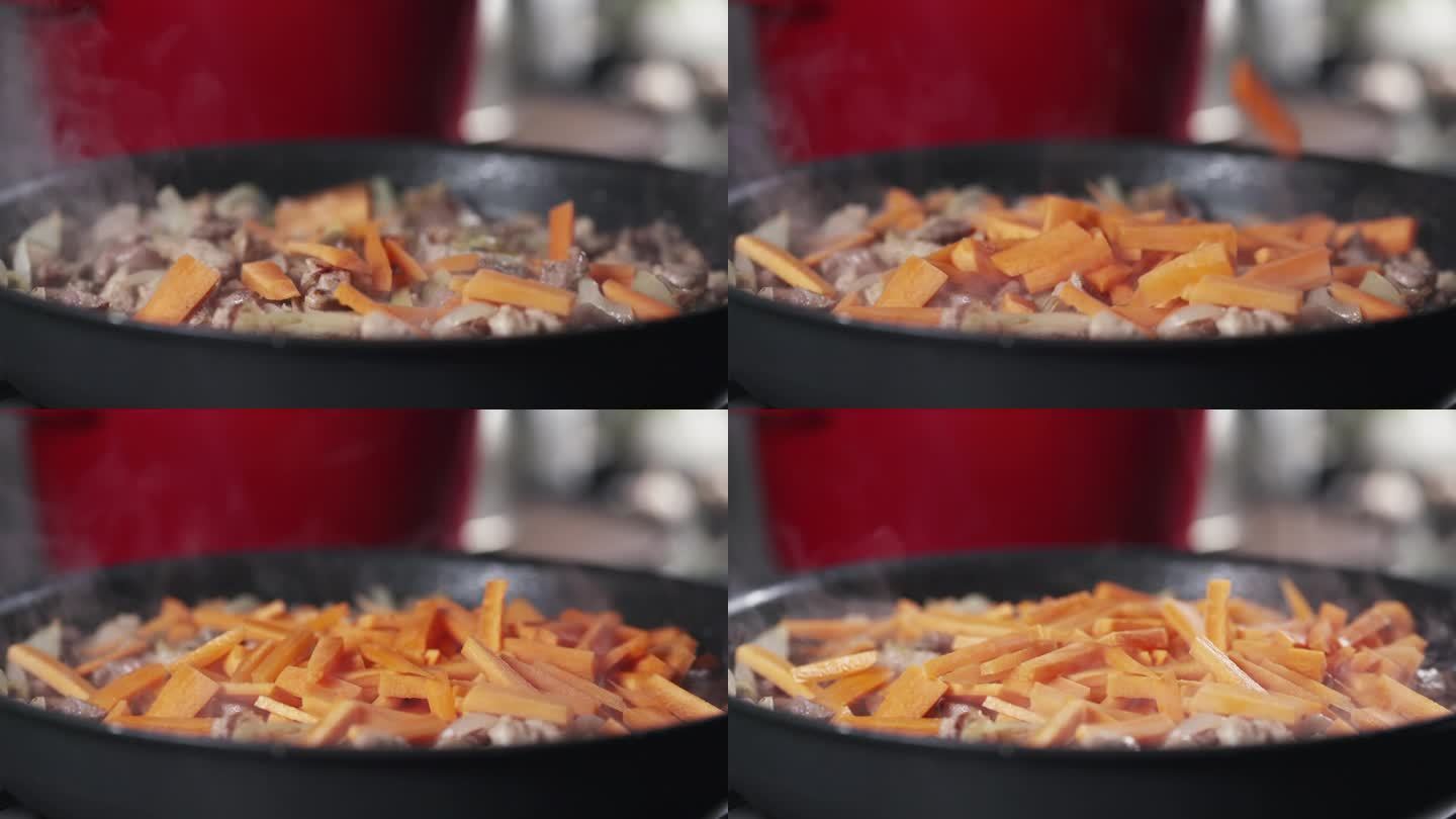 在锅里煎肉的胡萝卜落下的慢动作