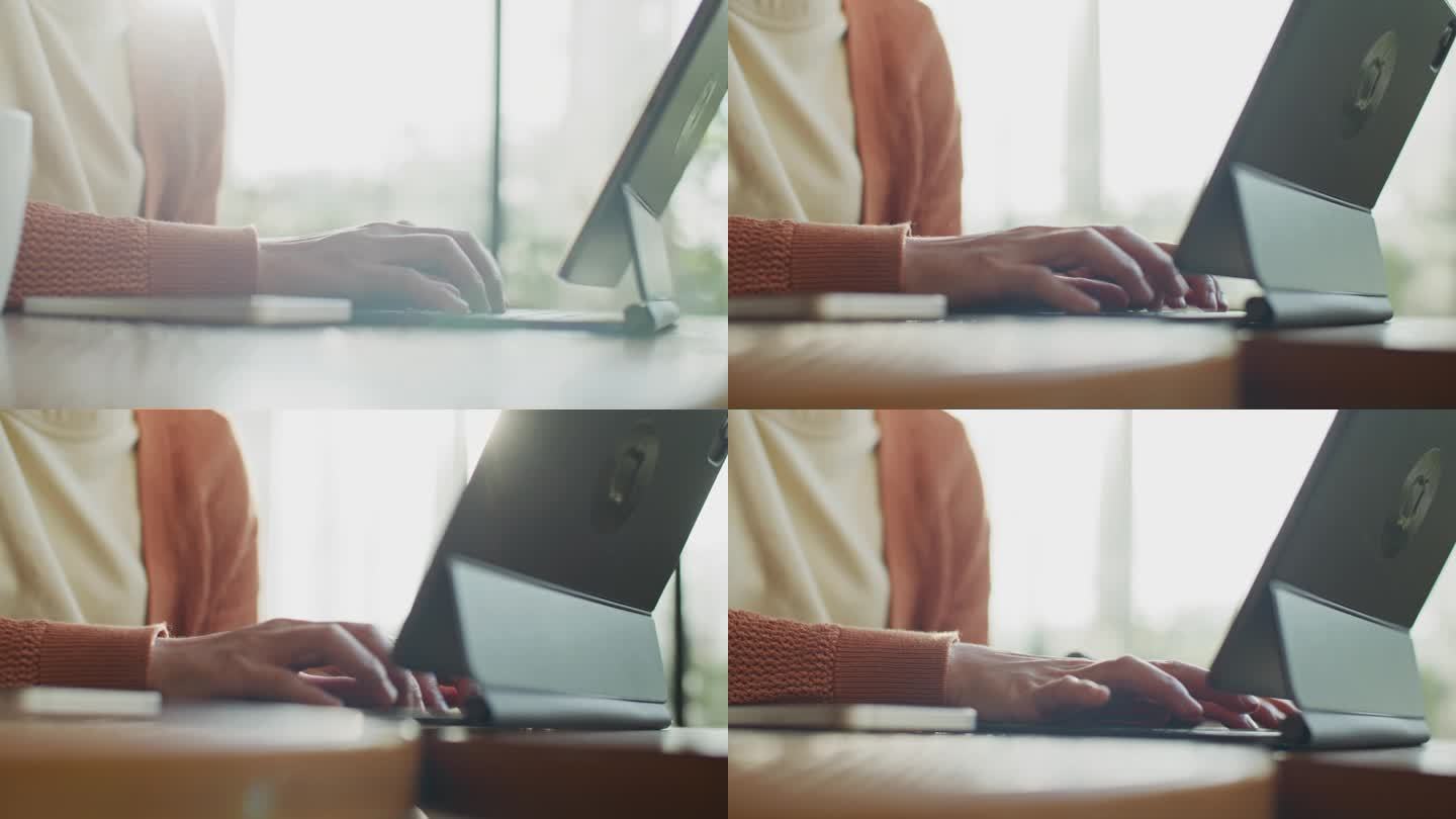 女性的手使用笔记本电脑，在键盘上打字