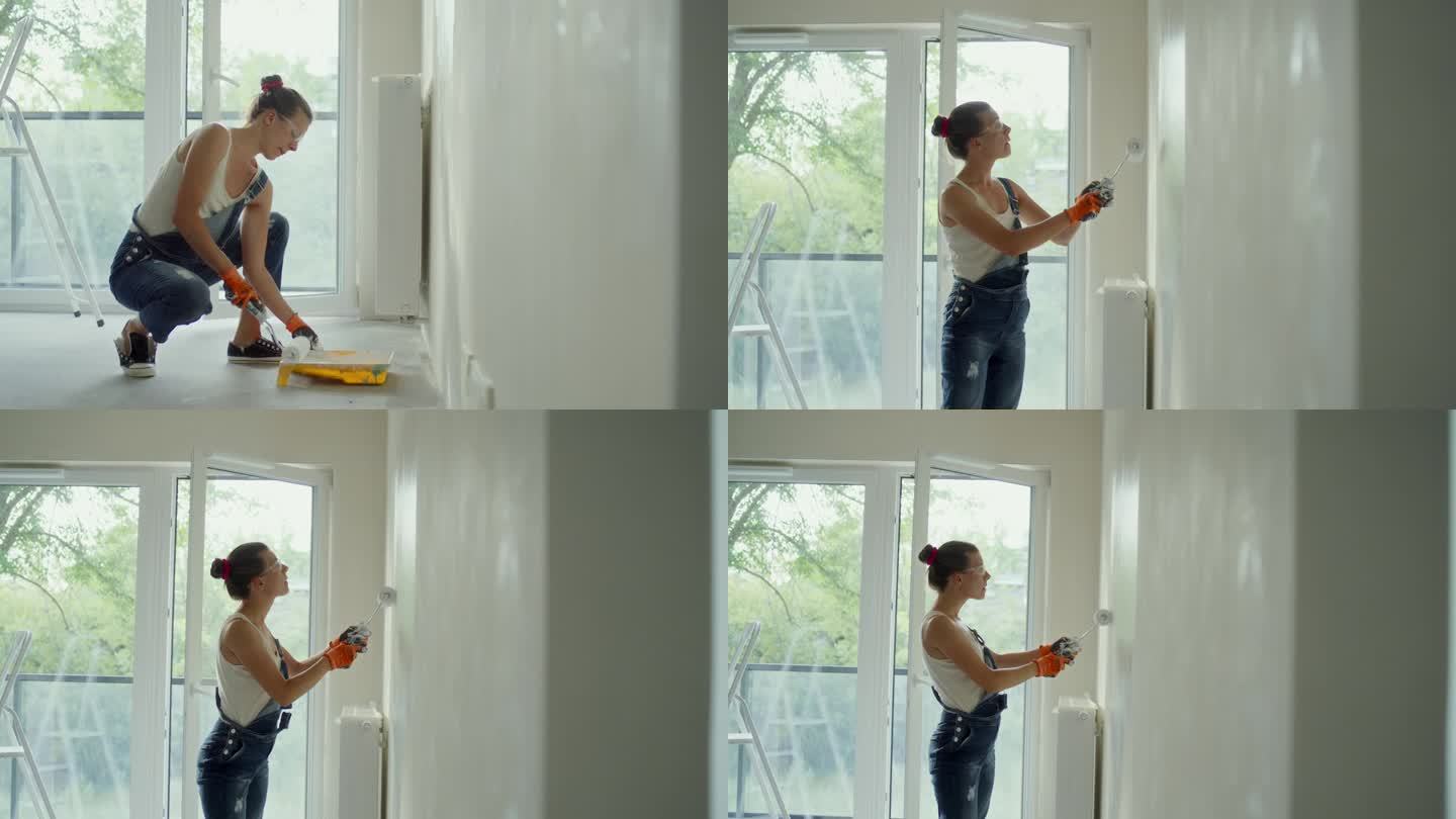 年轻女子用油漆滚筒刷着她梦想中的房子墙壁