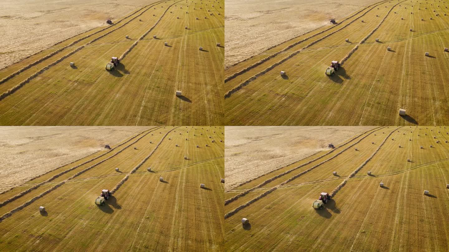 小麦收获后，两辆拖拉机和打包机在农田里打干草