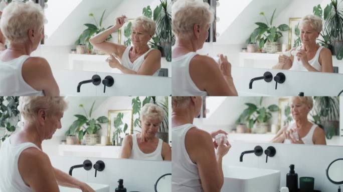 老年白人妇女正在使用止汗剂。用RED氦相机在8K下拍摄。