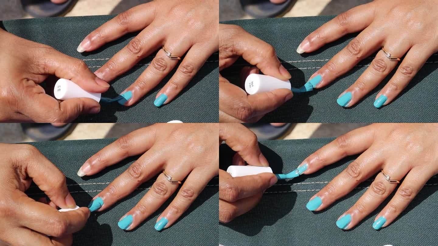 女人在家里做美甲、保养指甲时，用亮色指甲油涂指甲。自我关怀