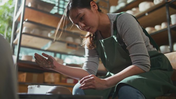 特写，妇女在家庭工作室使用陶轮