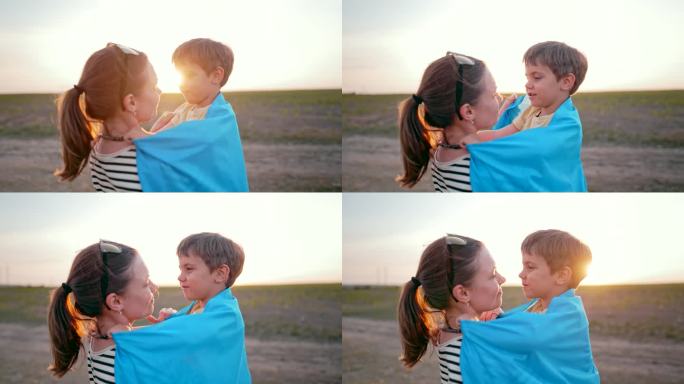 乌克兰爱家的儿子微笑着紧紧地拥抱着妈妈。温柔的场景。可爱的3岁小孩和妈妈。乌克兰的和平，下一代，亲子