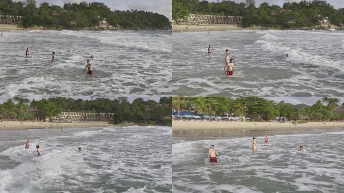 HDR泰国普吉岛卡伦海滩游客在水中嬉戏