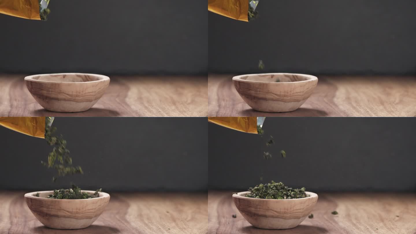 慢动作将干绿乌龙茶倒入木碗中，摆上有复制空间的木桌