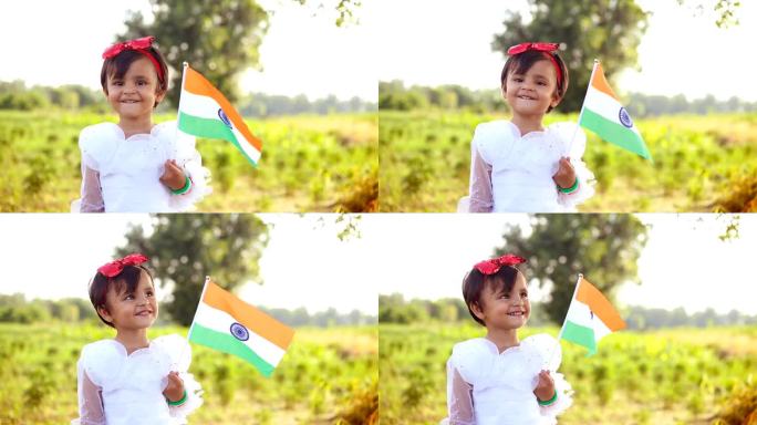 可爱的女儿在独立日举着印度国旗