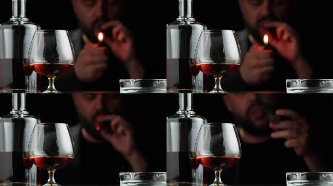 白兰地或威士忌加雪茄特写。富人抽烟。黑色背景的豪华干邑。酒精琥珀饮料，饮用朗姆酒，酒精饮料在玻璃。
