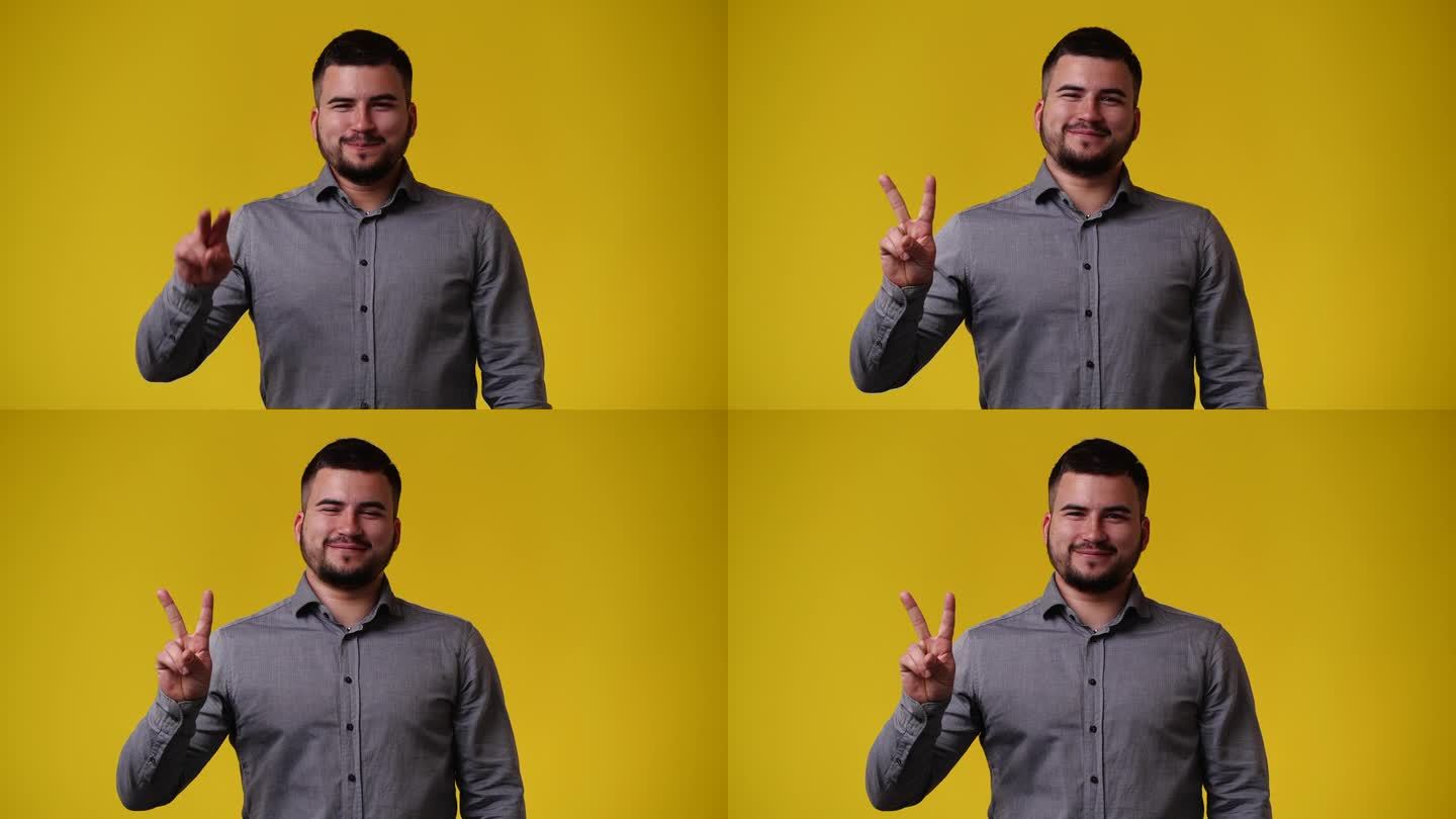 一段4k视频显示，一名男子微笑着向黄色背景的男子打招呼。