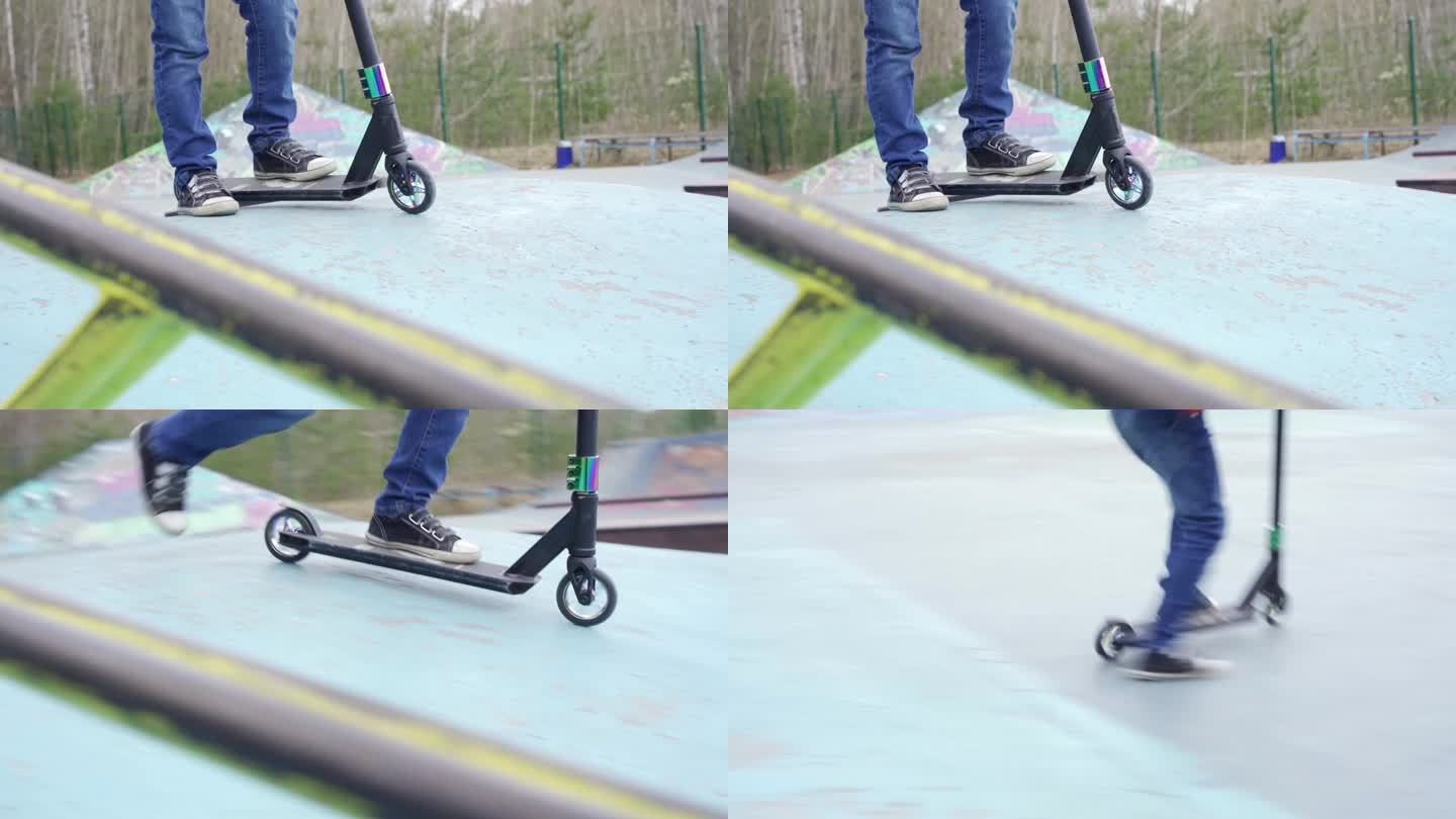 一个快乐的男孩在滑板公园骑着特技滑板车。