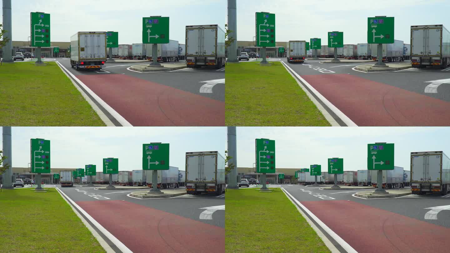 在高速公路服务区的停车场，空置的汽车信息标志和大型卡车。