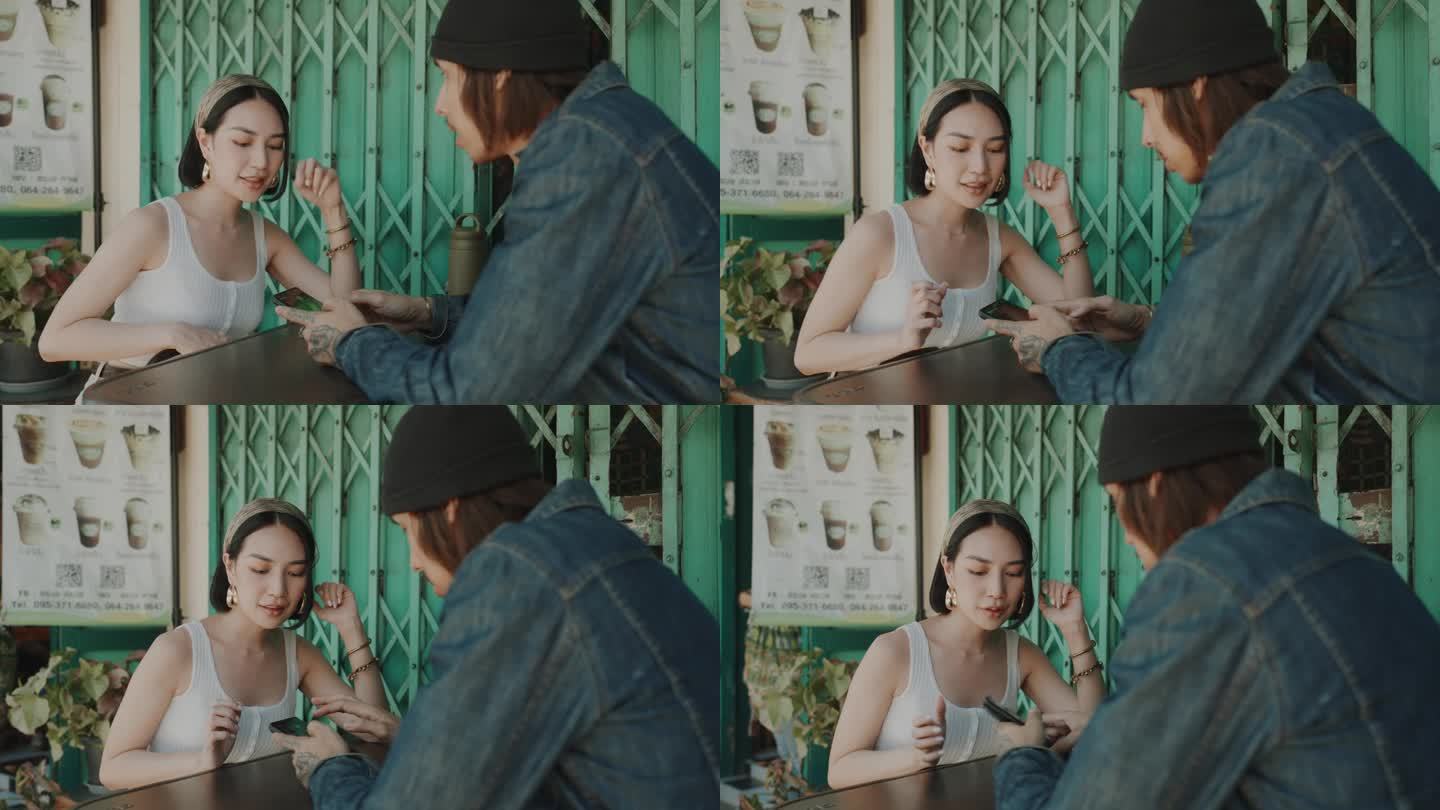 年轻夫妇在迷人的曼谷老城沉迷于街头甜点，用智能手机捕捉回忆。