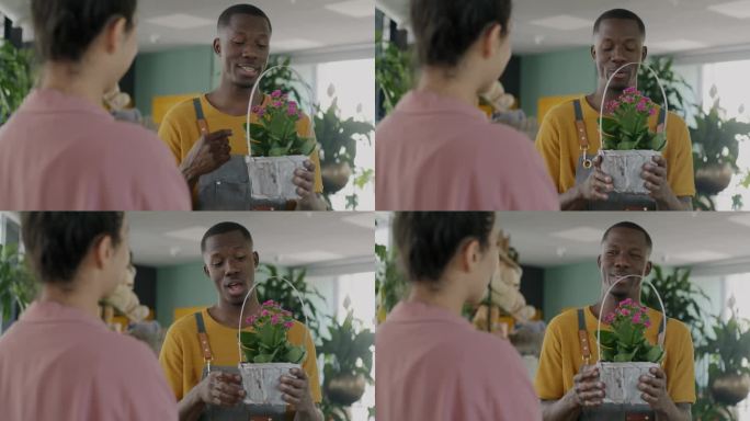 非洲裔美国推销员与女性客户谈论花店中盛开的植物