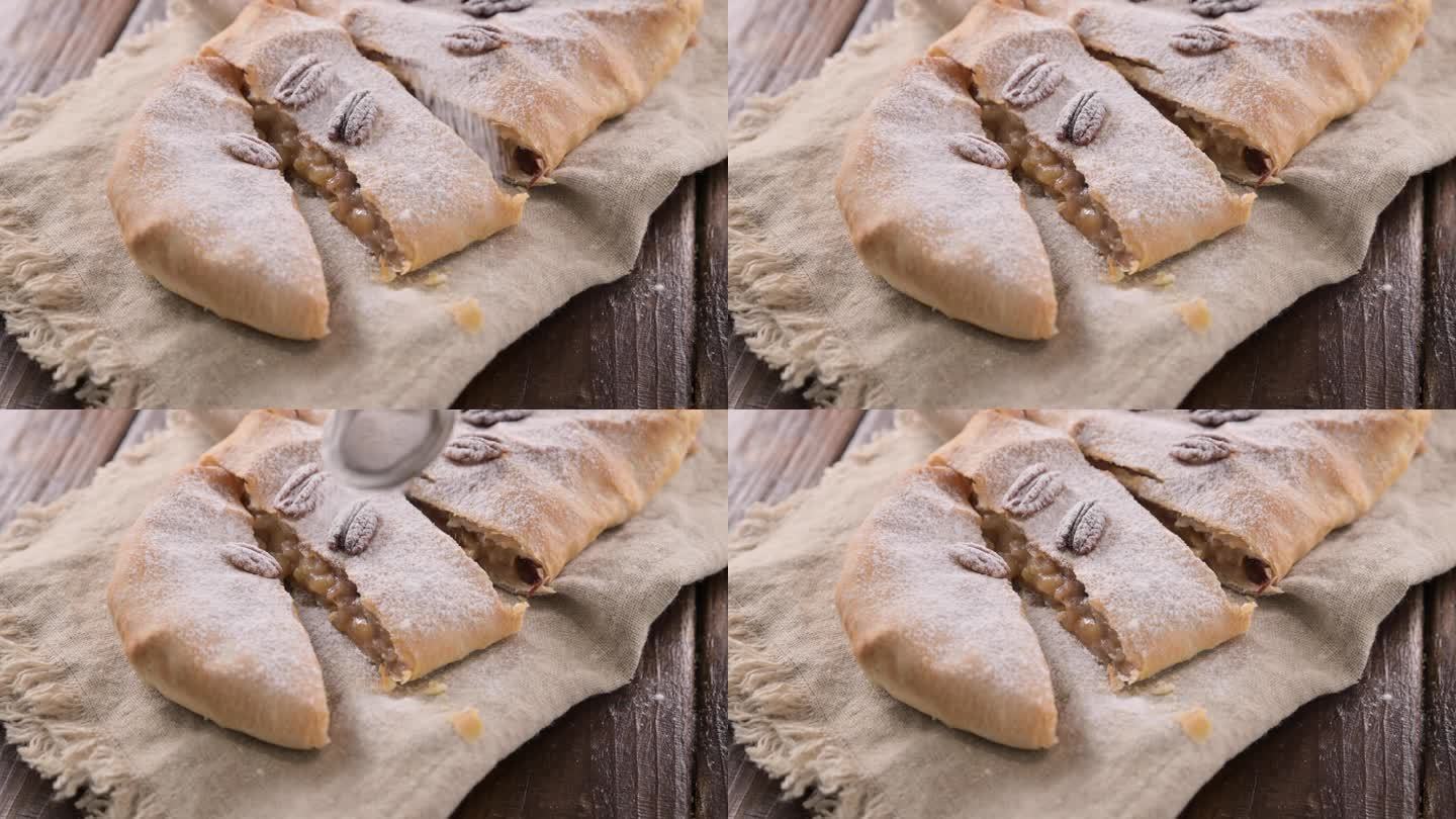 苹果馅饼。意大利北部特伦托的一种典型甜点。苹果，肉桂，坚果，酥皮，撒上糖粉。垂直的观点。
