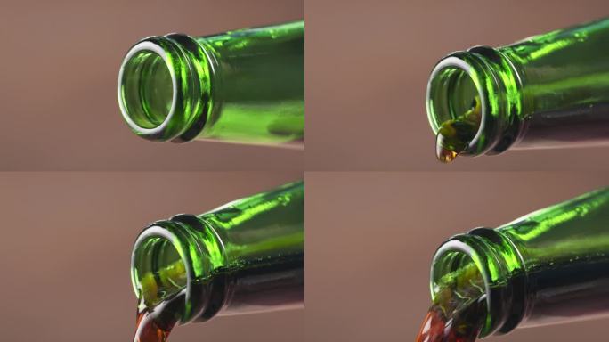慢动作宏观黑啤从绿色的瓶子倒出来