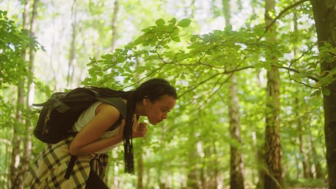 背着背包穿过森林的女人