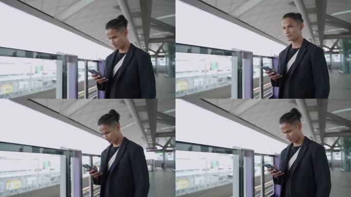 男子在火车站使用智能手机