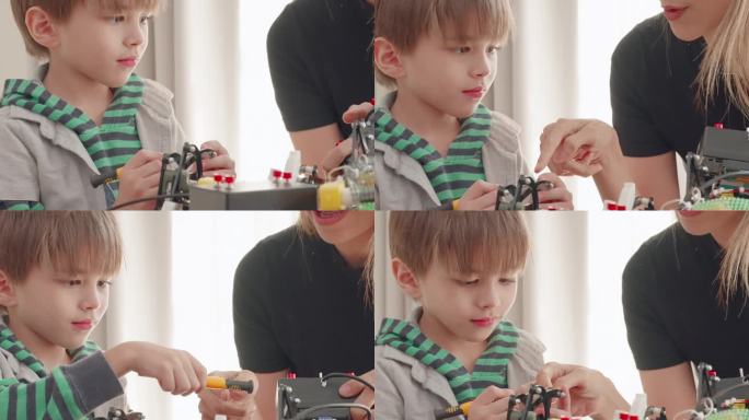 年轻快乐的家庭，妈妈或保姆帮助可爱的孩子一起制作组装和修理机器人玩具，在家里的客厅里享受创造性的活动