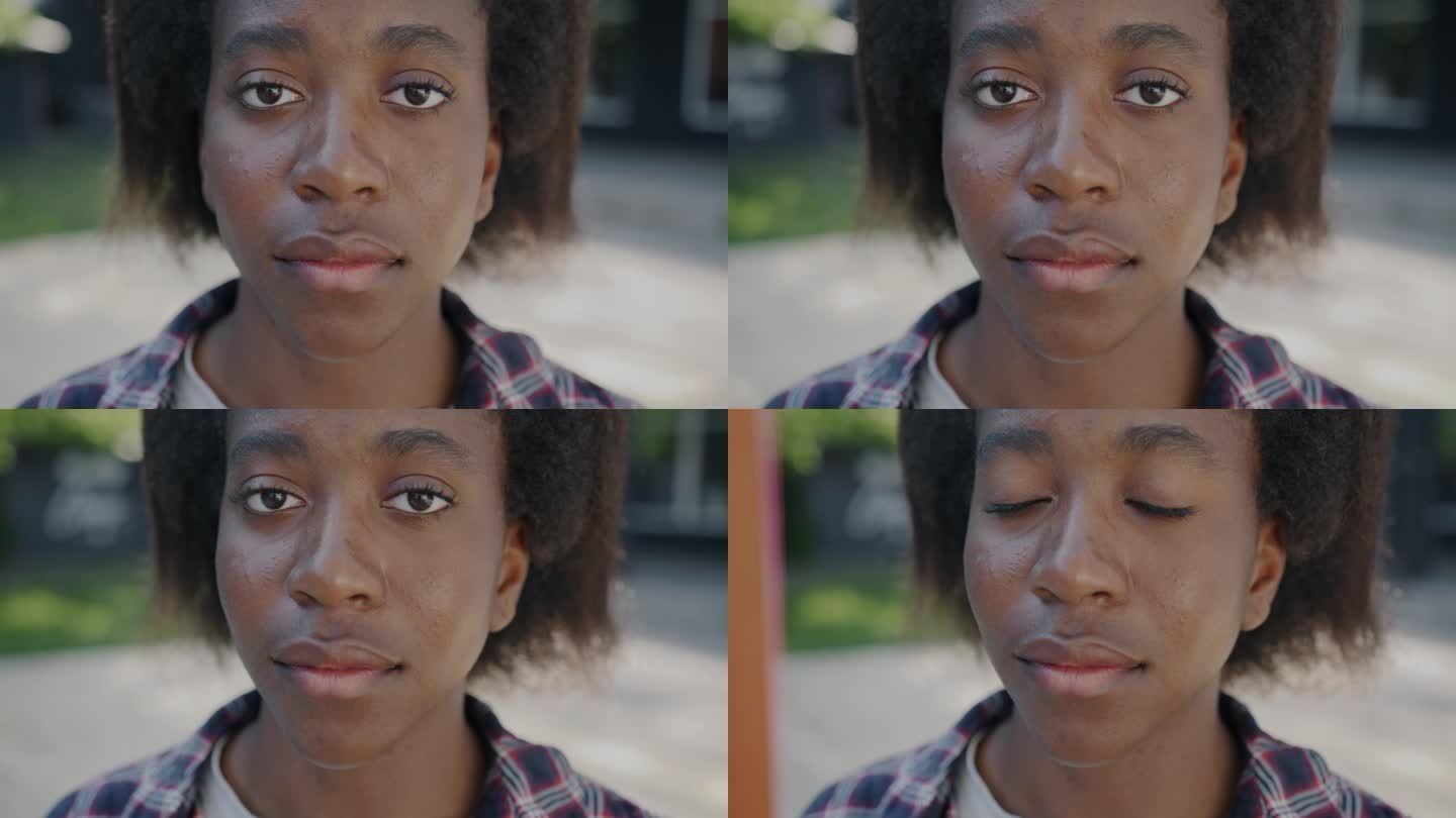 一个悲伤的非裔美国人在城市里看着镜头，表情沮丧的特写