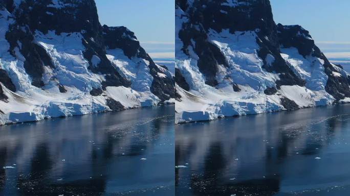 垂直镜头令人惊叹的景观雪山在南极海洋。