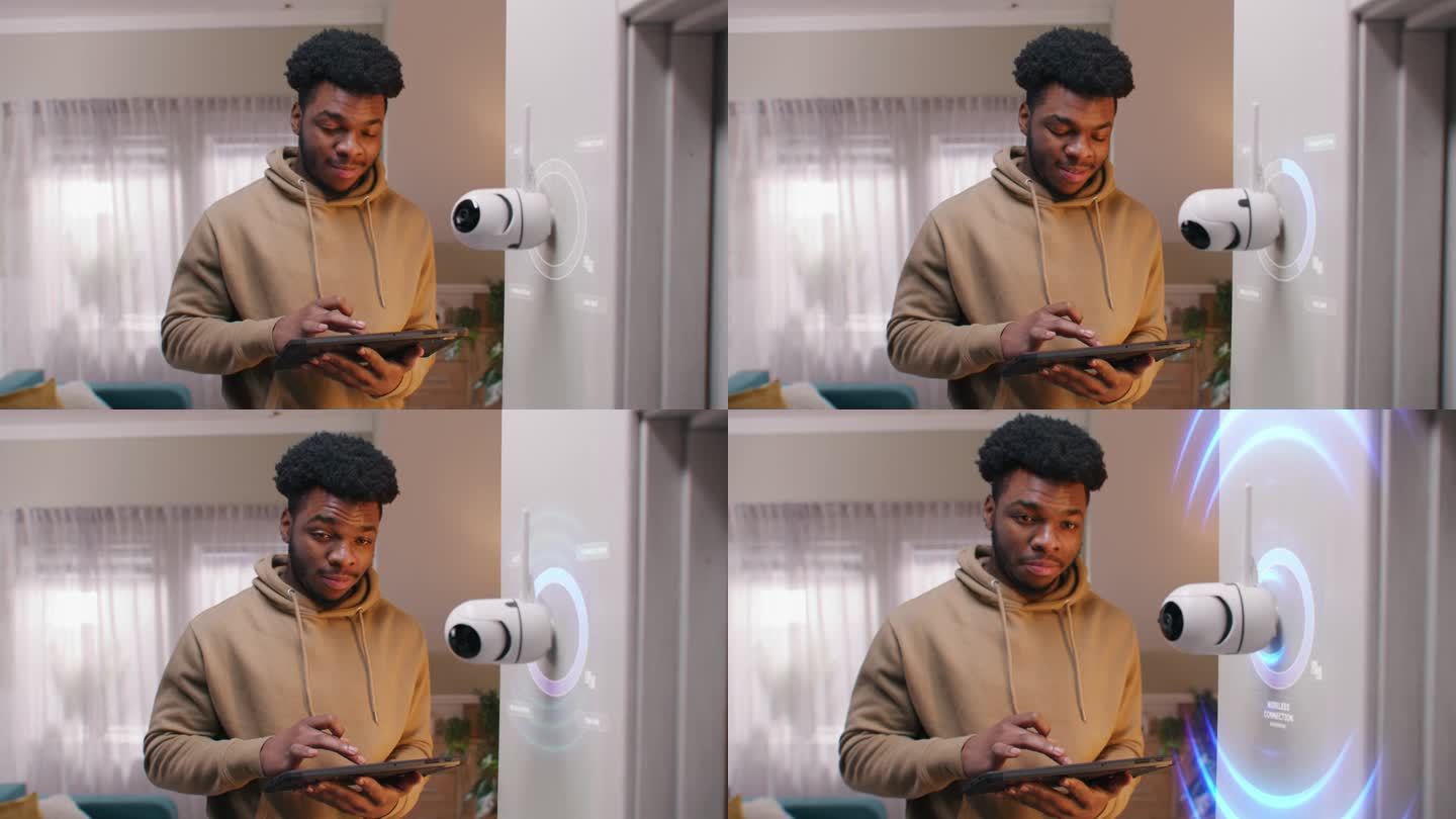 一名非裔美国男子用数码平板电脑安装了安全摄像头