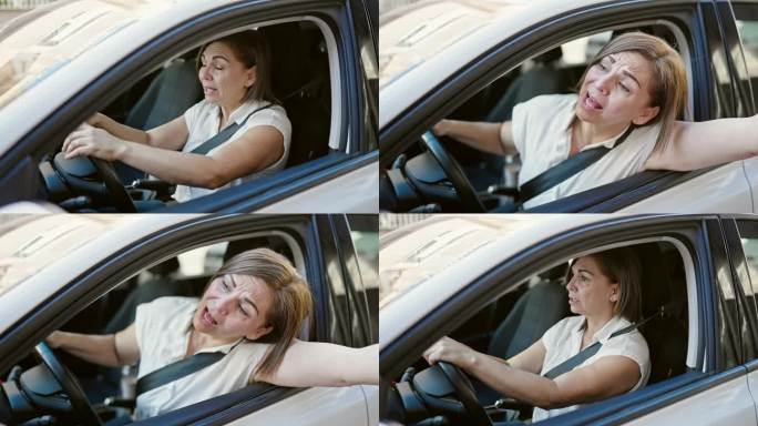 中年西班牙妇女在街上开车很紧张
