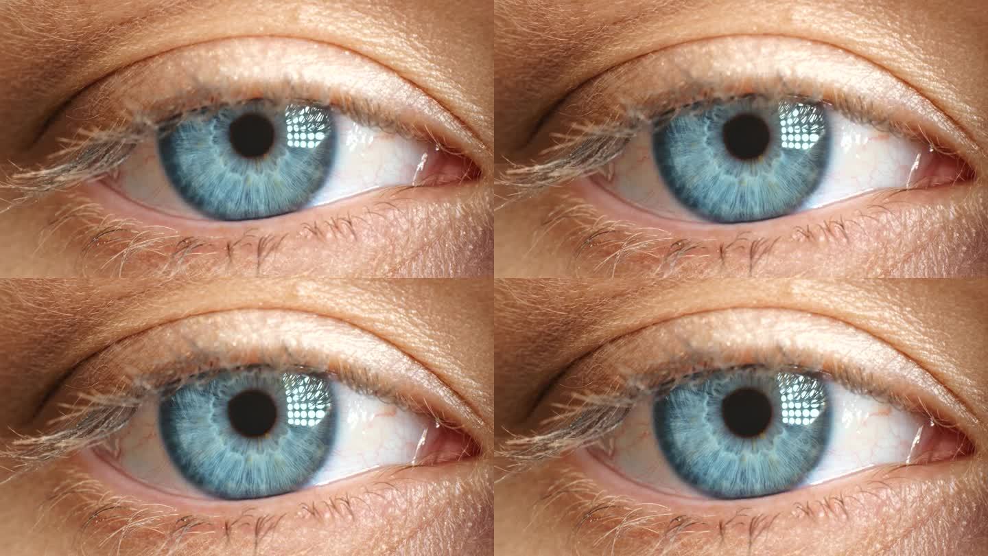 验光师检查瞳孔的宏观蓝眼、虹膜和视力，或为医疗保健使用隐形眼镜。特写肖像的人的眼球打开在视线，缩放和