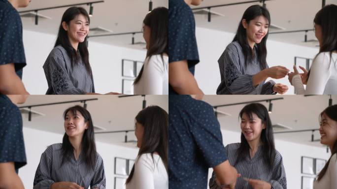 亚洲华人企业家在咖啡馆的休息室里，在社交会议上握手并交换名片