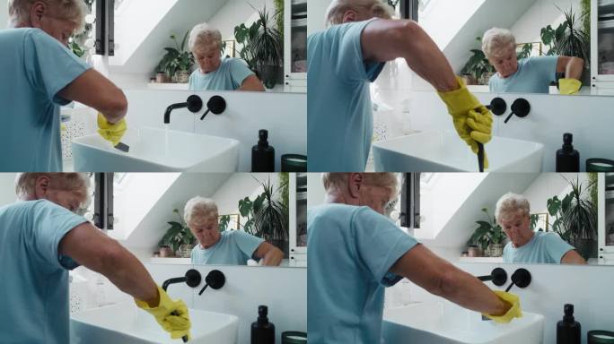 白人老年妇女在打扫浴室水槽。用RED氦气摄影机4K拍摄。
