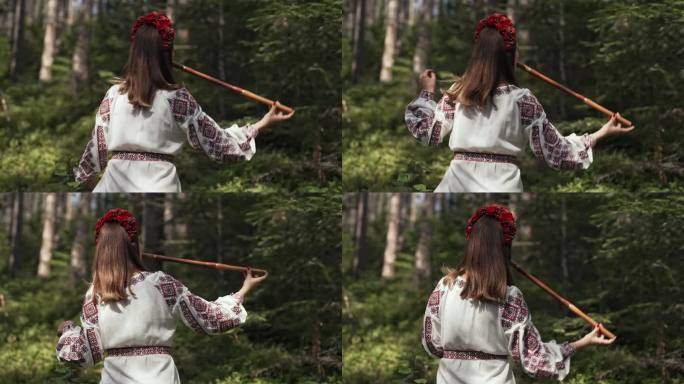 无法辨认的妇女演奏木管木笛-乌克兰特伦卡或泰林卡在森林背景。民间音乐概念。乐器。身穿传统刺绣衬衫的音