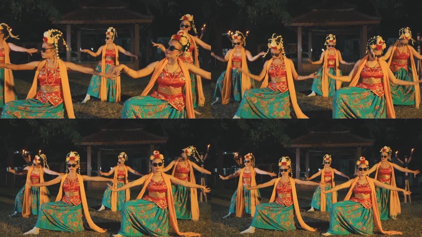 一群传统的巽他舞者穿着黄色的服装在空旷的田野上跳舞