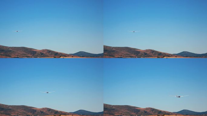 滑翔机进场降落在山的背景