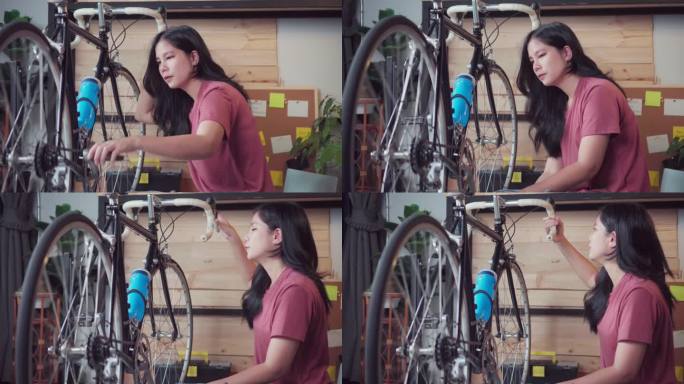 亚洲女性在家车库自己修理和保养自行车的断裂和链条，潮女小企业主在自行车车间工作。