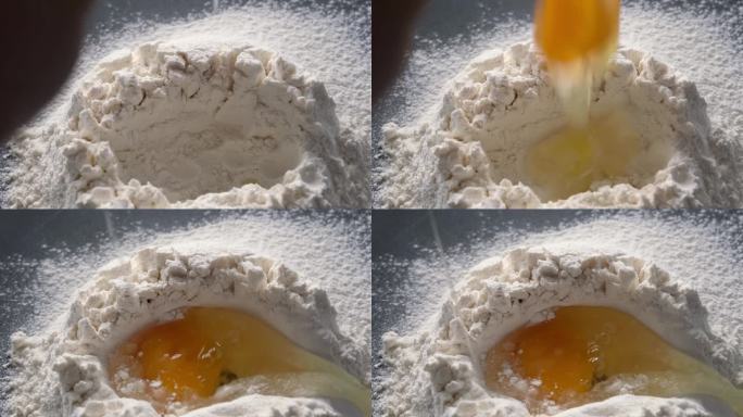 一个生鸡蛋被打碎成一堆面粉，它慢慢落下，烘焙的食材都是特写，家庭厨房里的烹饪过程