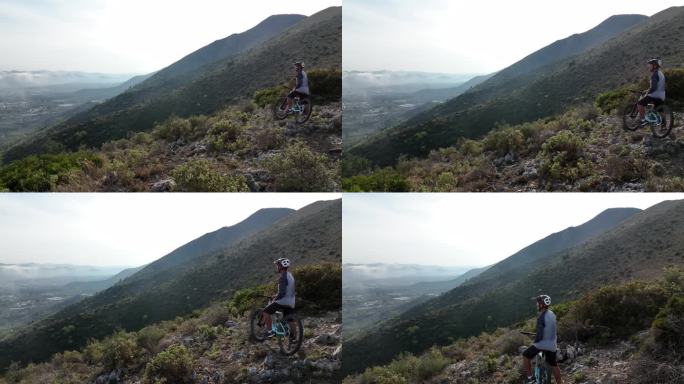 资深男性山地自行车手穿越崎岖的山脊