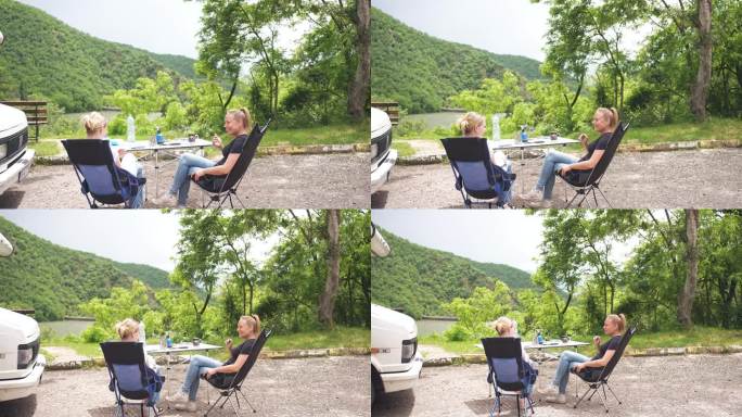 嬉皮女性在野餐时间享受湖景和愉快的交谈