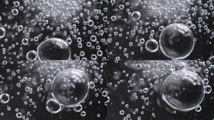 慢动作特写场景上的小气泡连接在一起成为一个更大的一个孤立的黑色背景，气泡质地的苏打水饮料时，气体释放