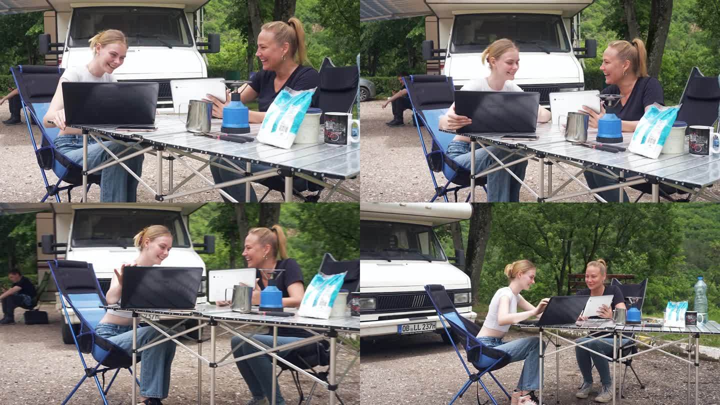 母亲和女儿在露营途中一边完成自由职业工作一边讨论股市