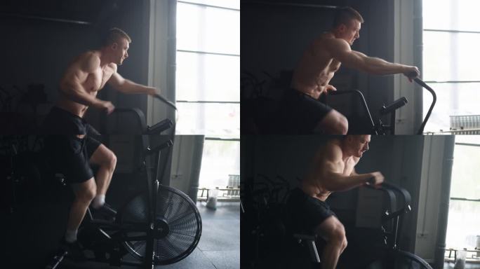 有氧运动在健身房的运动固定自行车，运动员旋转踏板，侧面视图