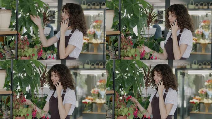 穿着围裙的花店老板年轻女子一边看着绿色植物和鲜花一边用手机和客户交谈