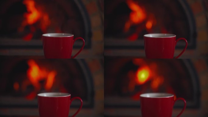 一杯茶的背景是燃烧着火焰的壁炉